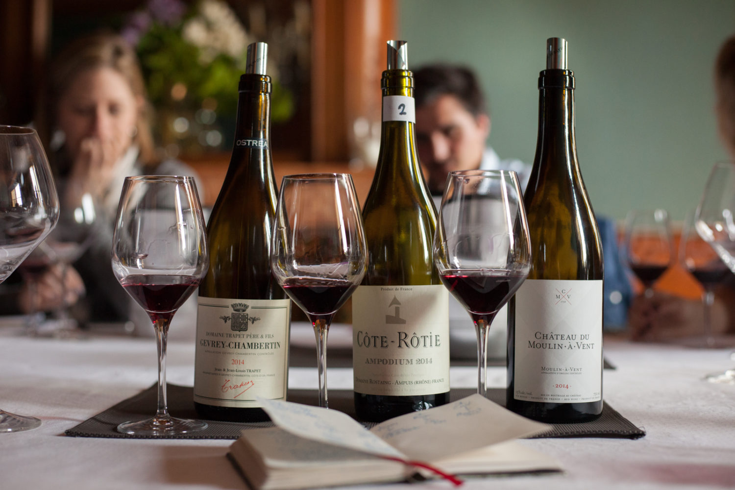 Bottles of Gevrey-Chambertin, Côte-Rôtie and Château du Moulin-à-Vent wine. ©Kevin Day / Opening a Bottle